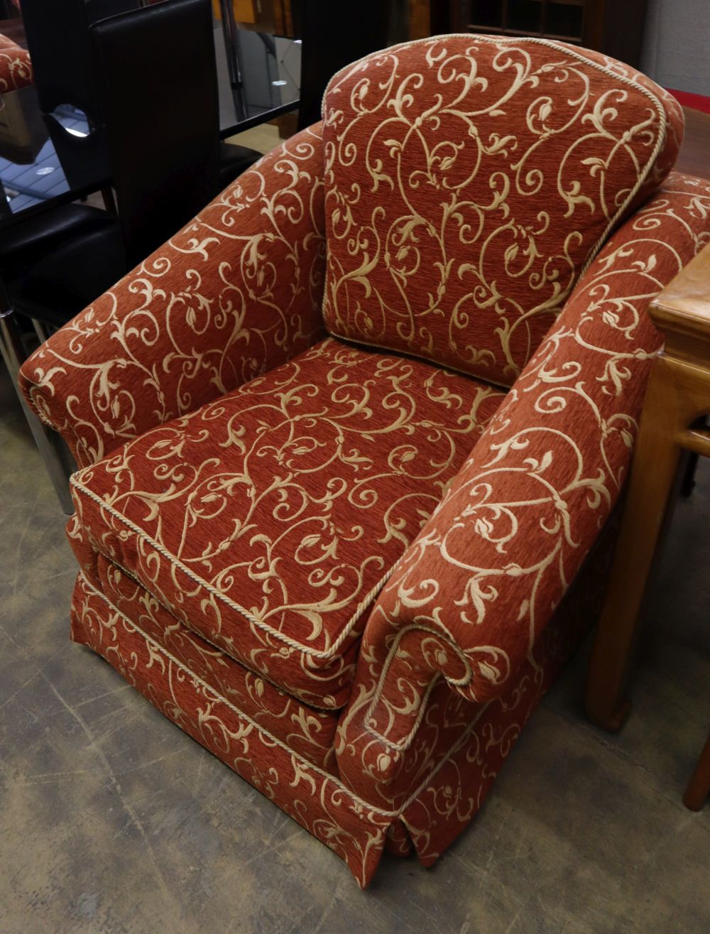 A pair of large modern armchairs, with cream scroll on rust ground upholstery, W.101cm